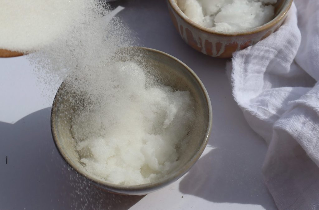 sugar being poured into a diy sugar scrub
